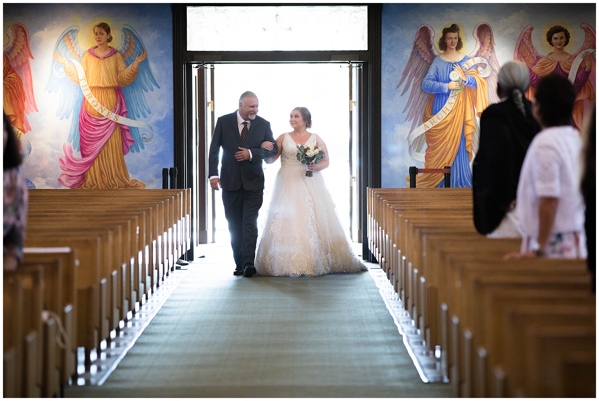 father is walking the bride down the aisle in catholic church wedding