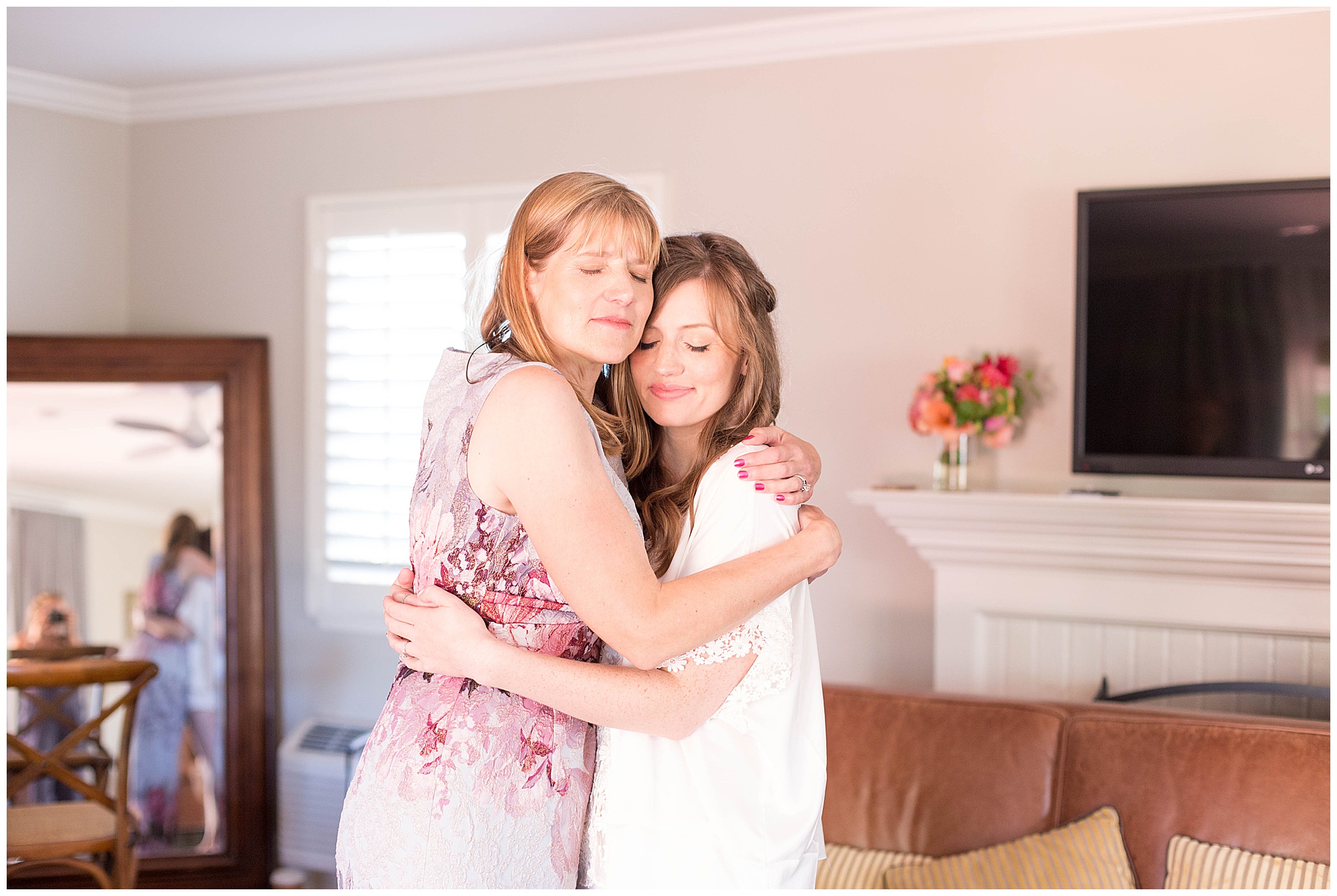 bride hugging her mom as she is getting ready
