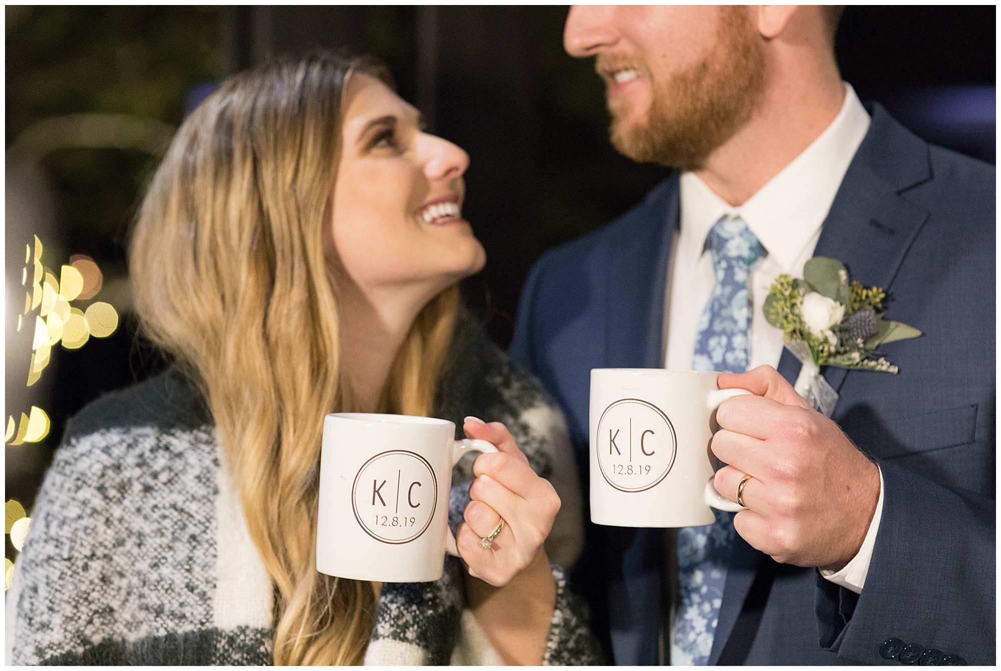 bride and groom holding personalized coffee mugs at wedding