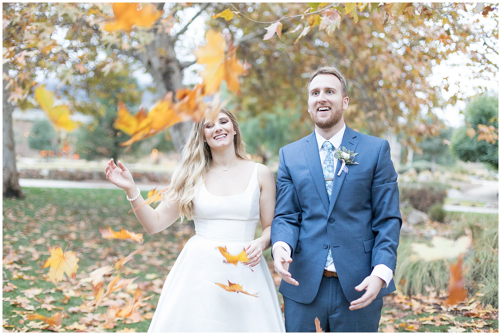 bride and groom throwing leaves