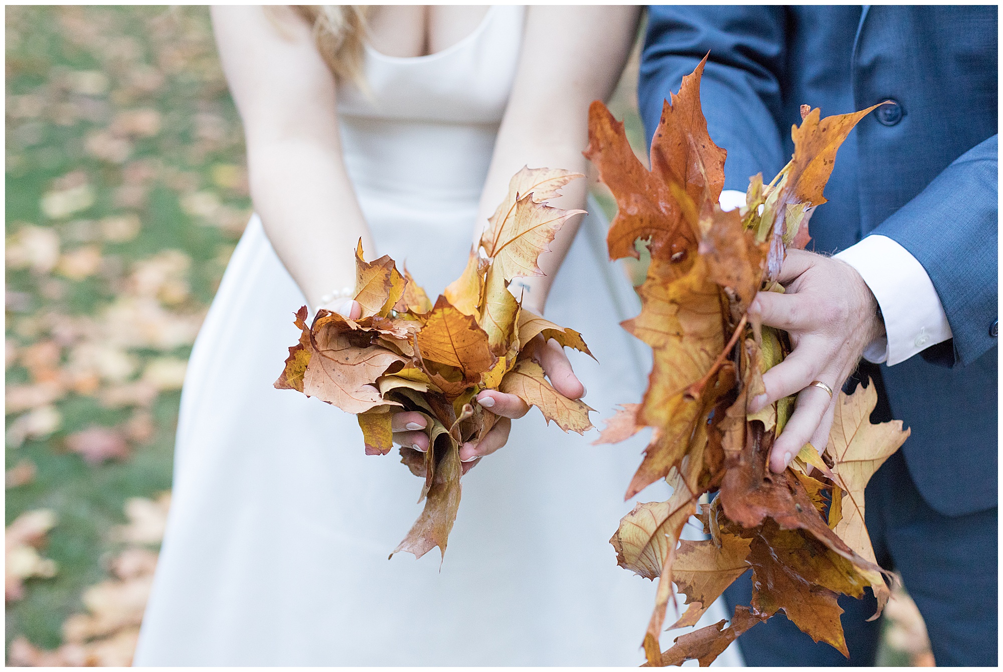 bride and groom holding leaves