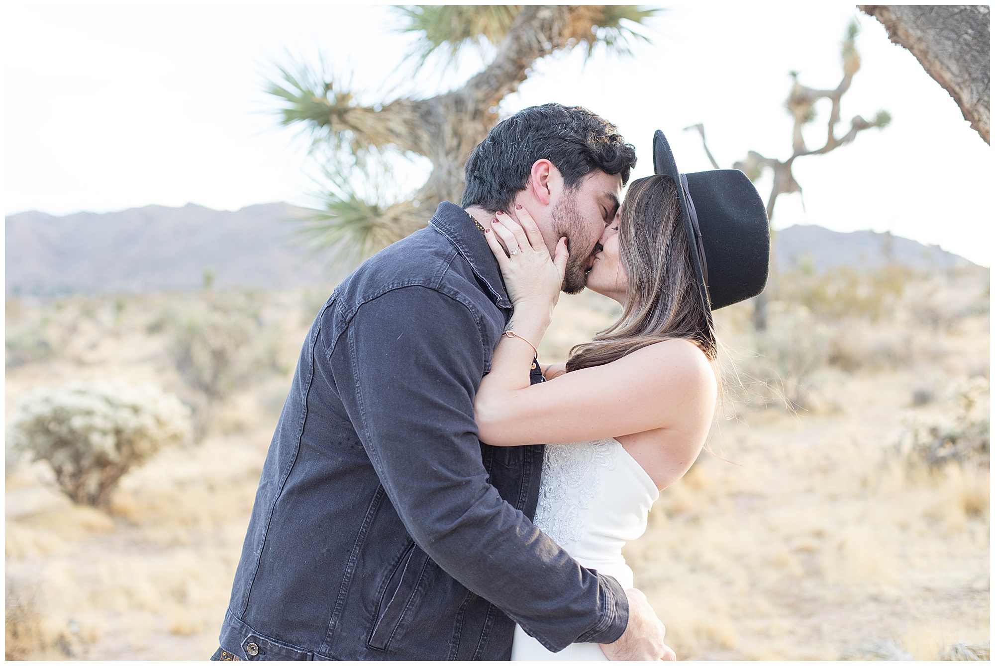 engaged couple kissing in joshua tree