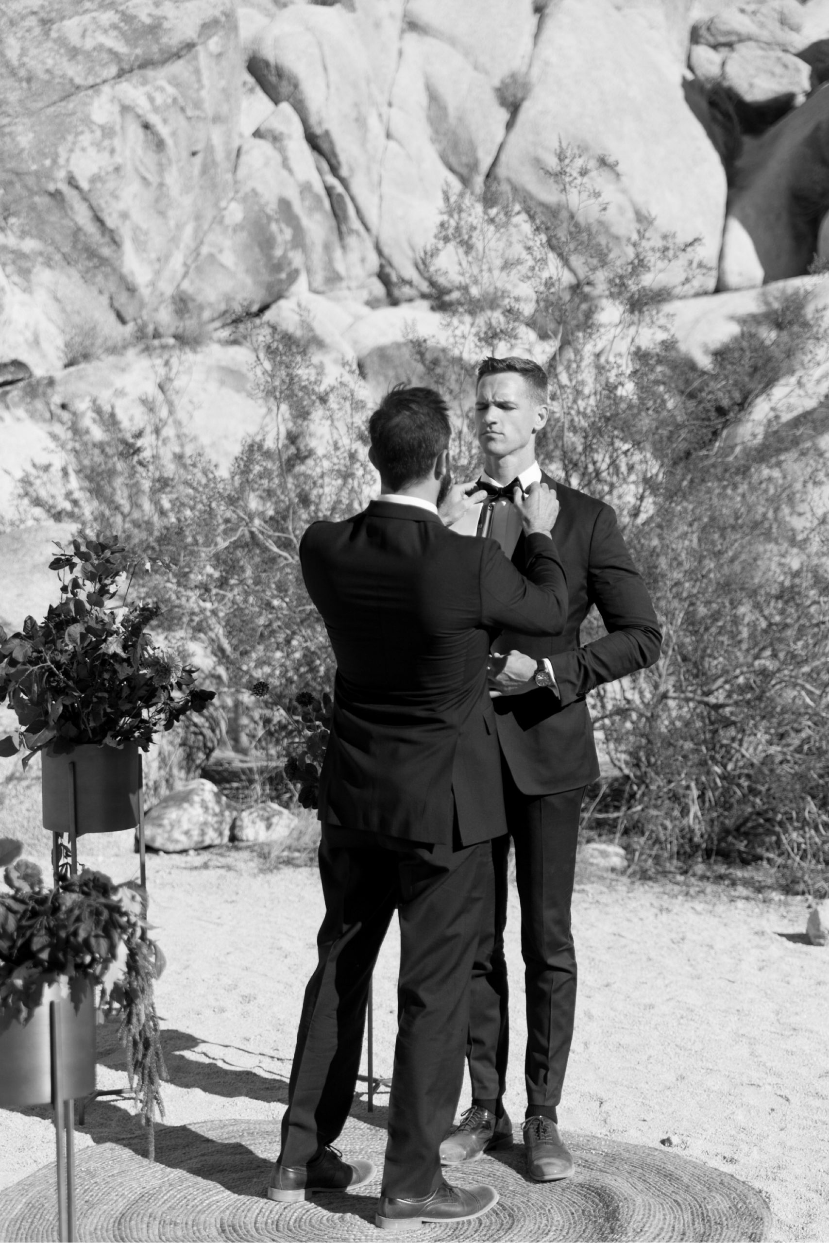 officiant fixing groom's tie at Indian Cove Amphitheater Wedding ceremony