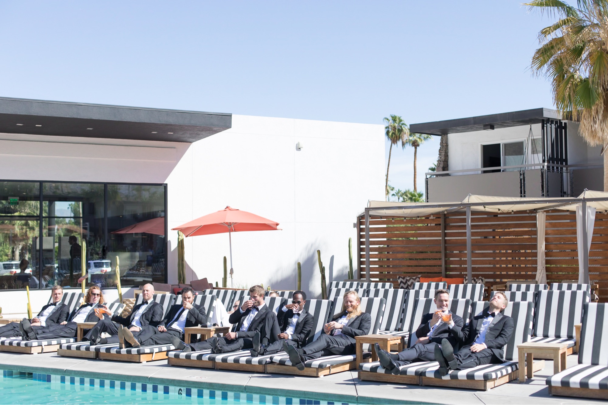 groomsmen lounging by pool in palm springs