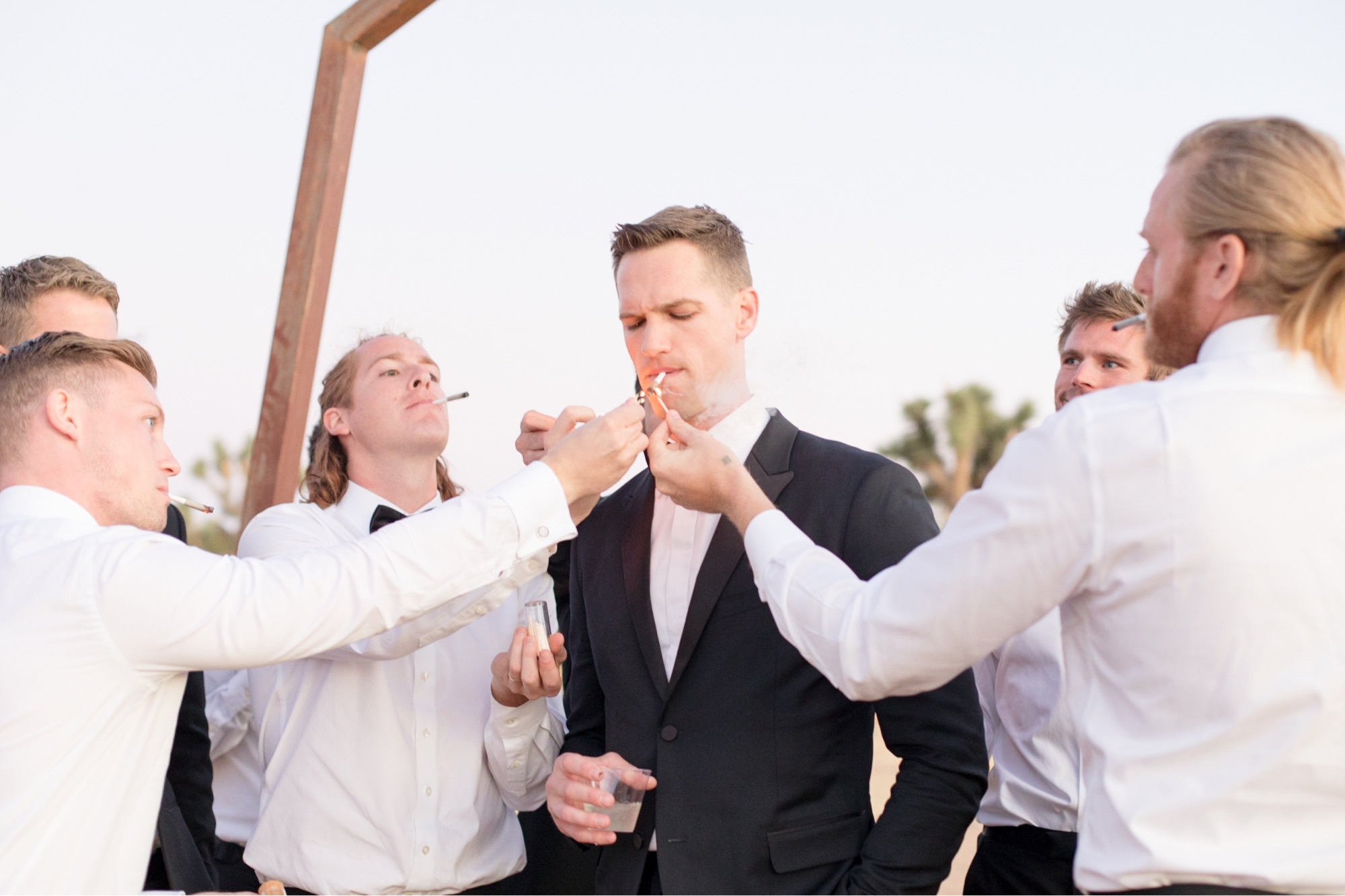 groom smoking a joint at wedding