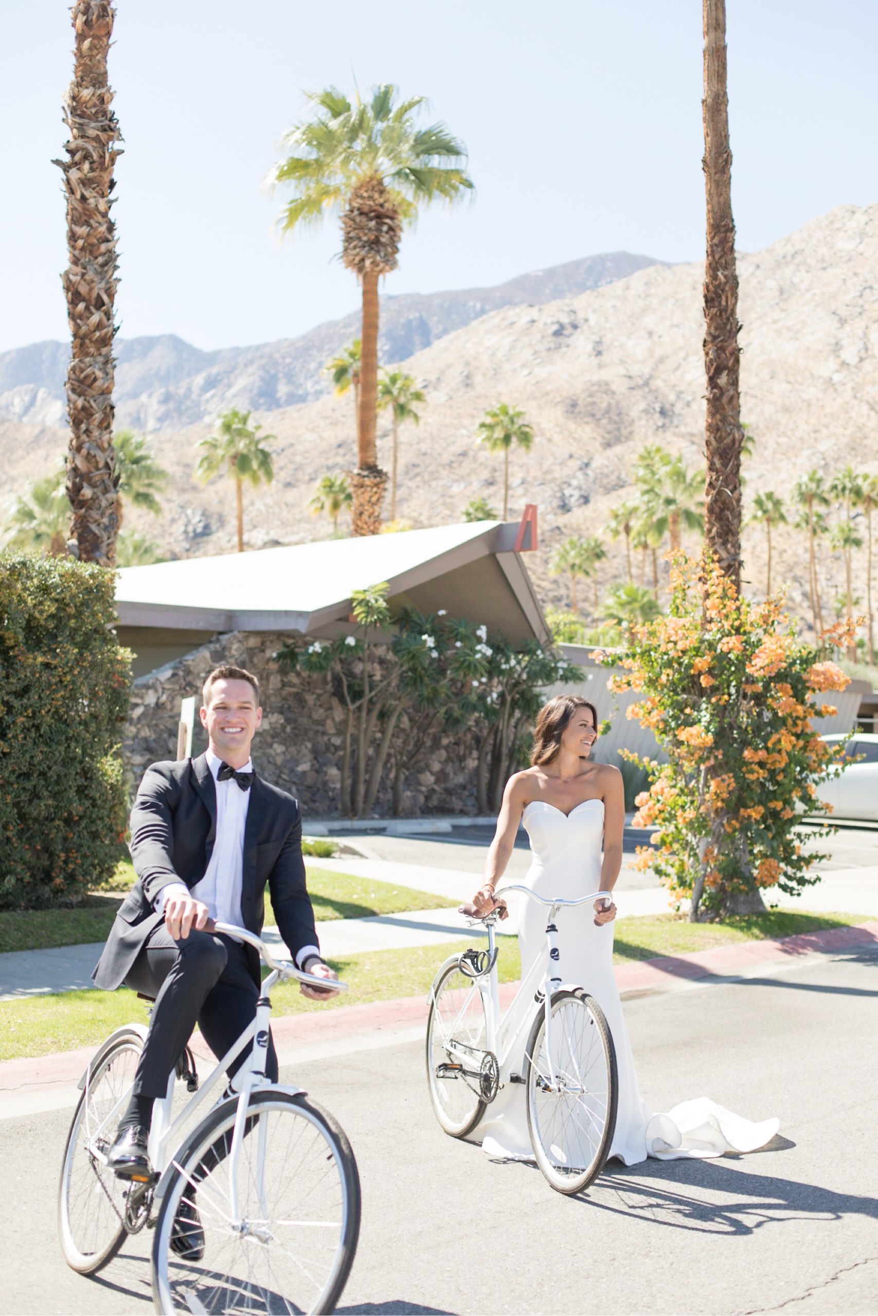 bride and groom riding bikes