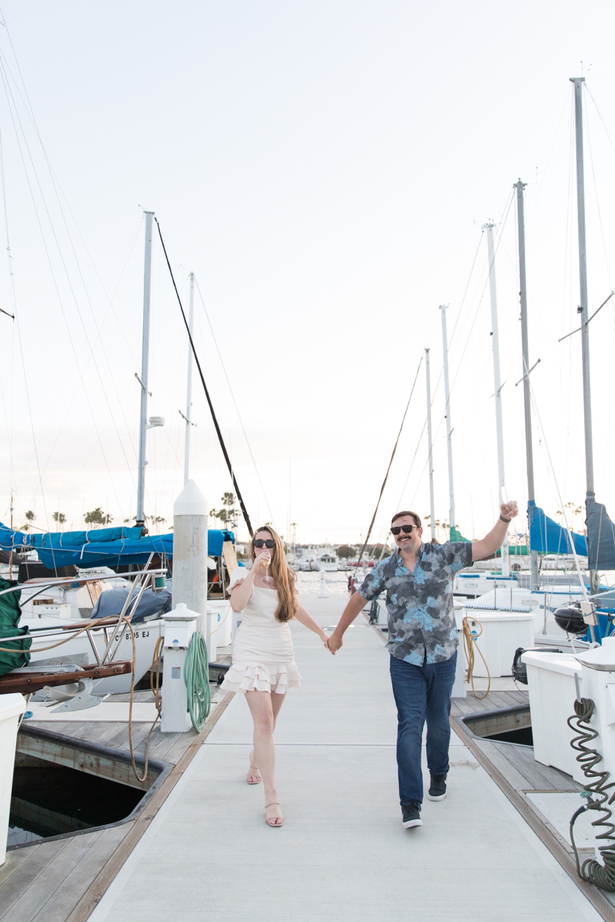 marina engagement session with champagne