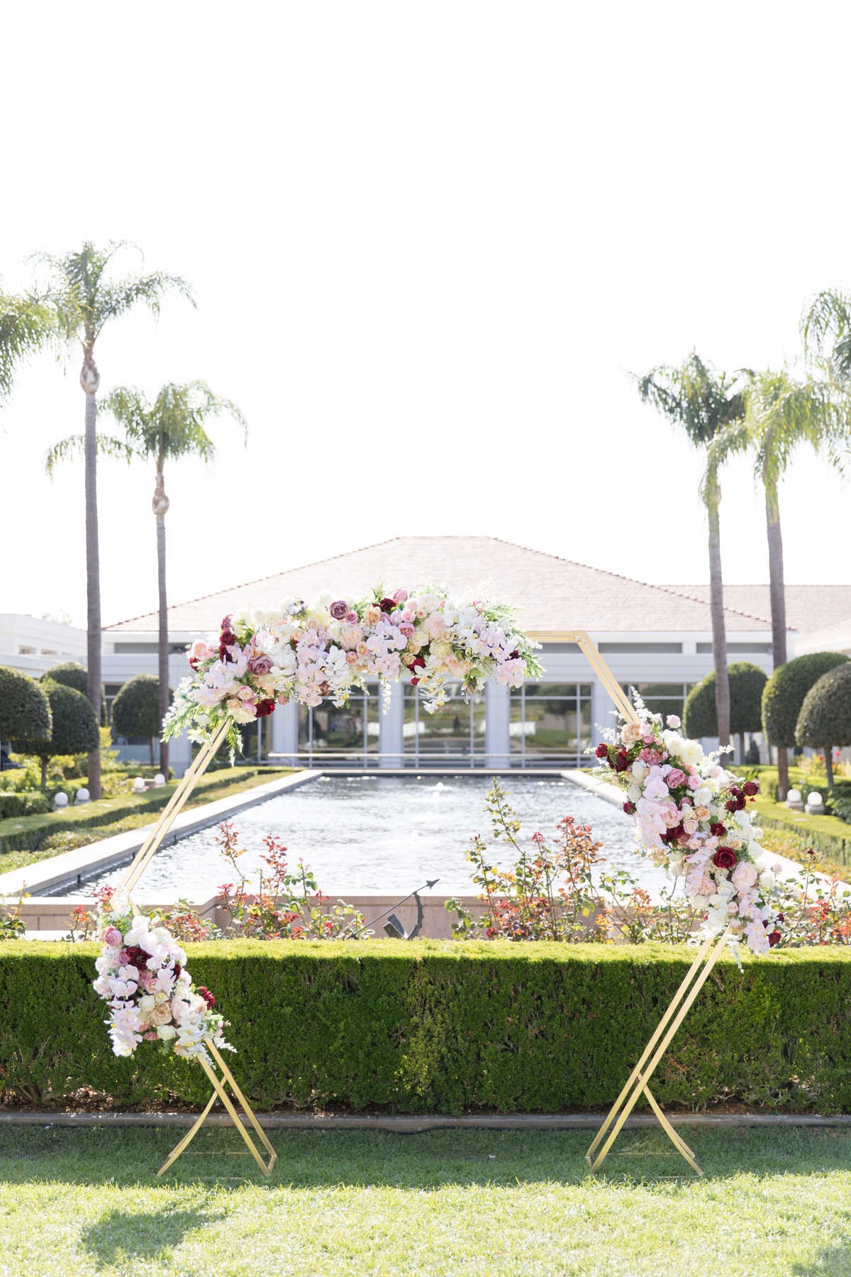 the richard nixon library wedding ceremony hexagon arch with flowers