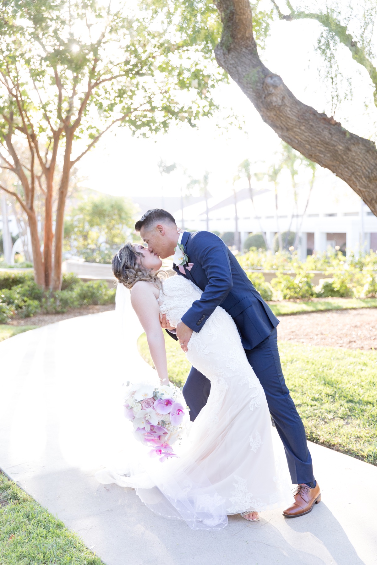 bride and groom kissing at orange county wedding venue