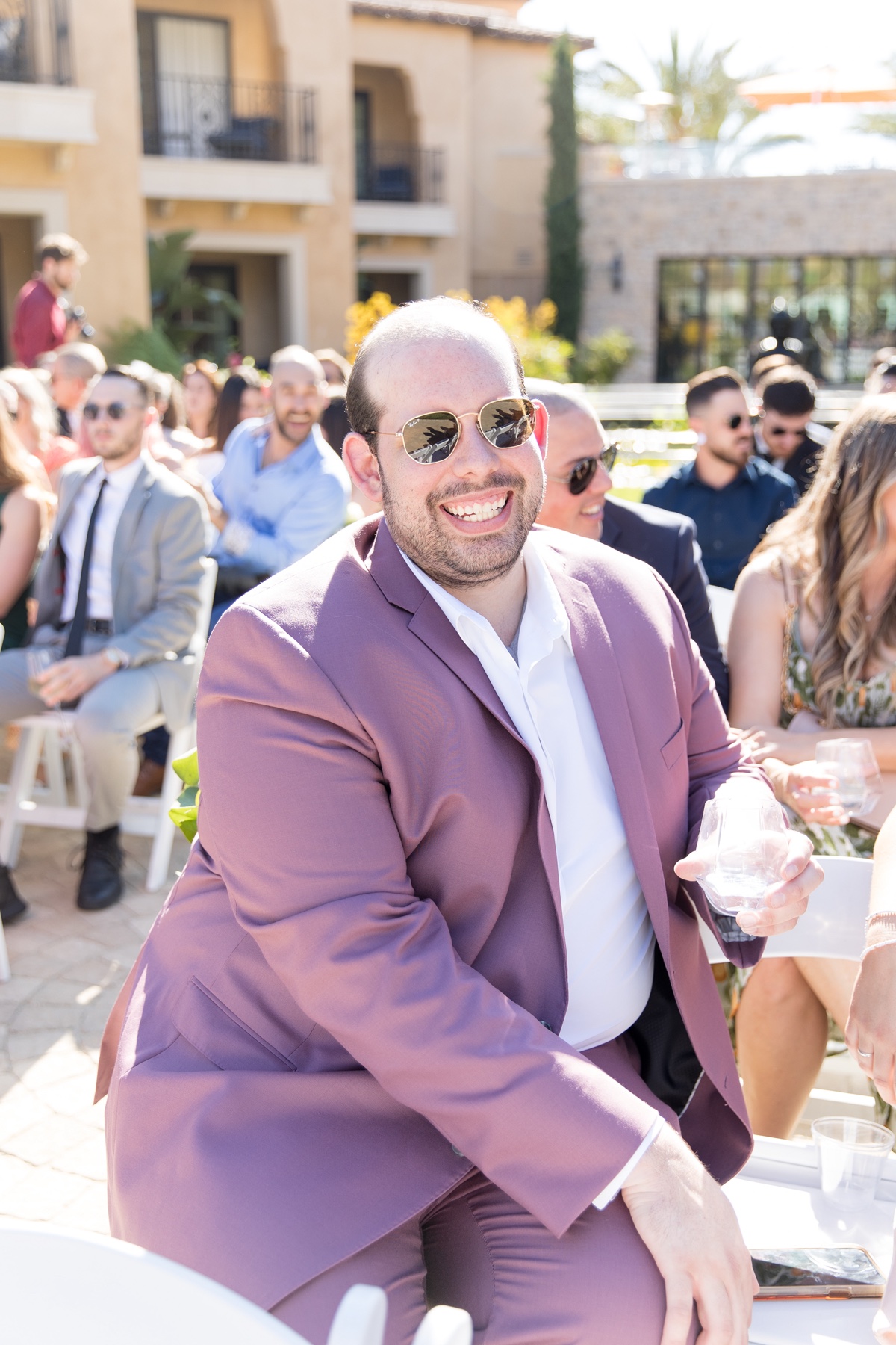 guest wearing ray bans at los angeles wedding and a purple suit