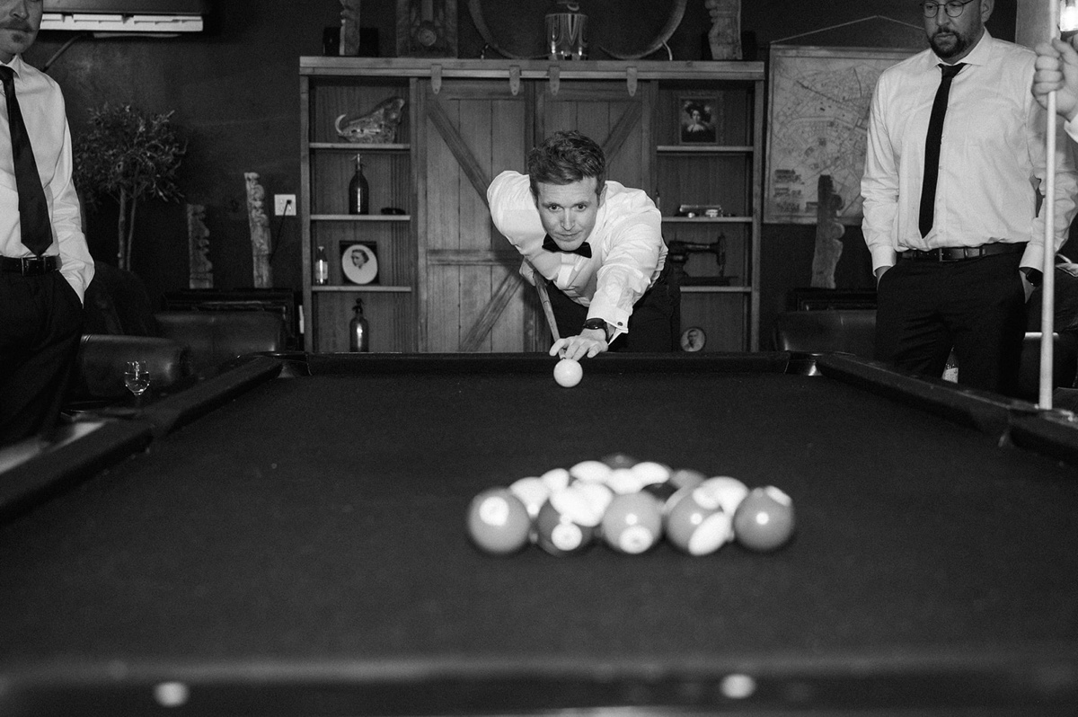 groom playing pool