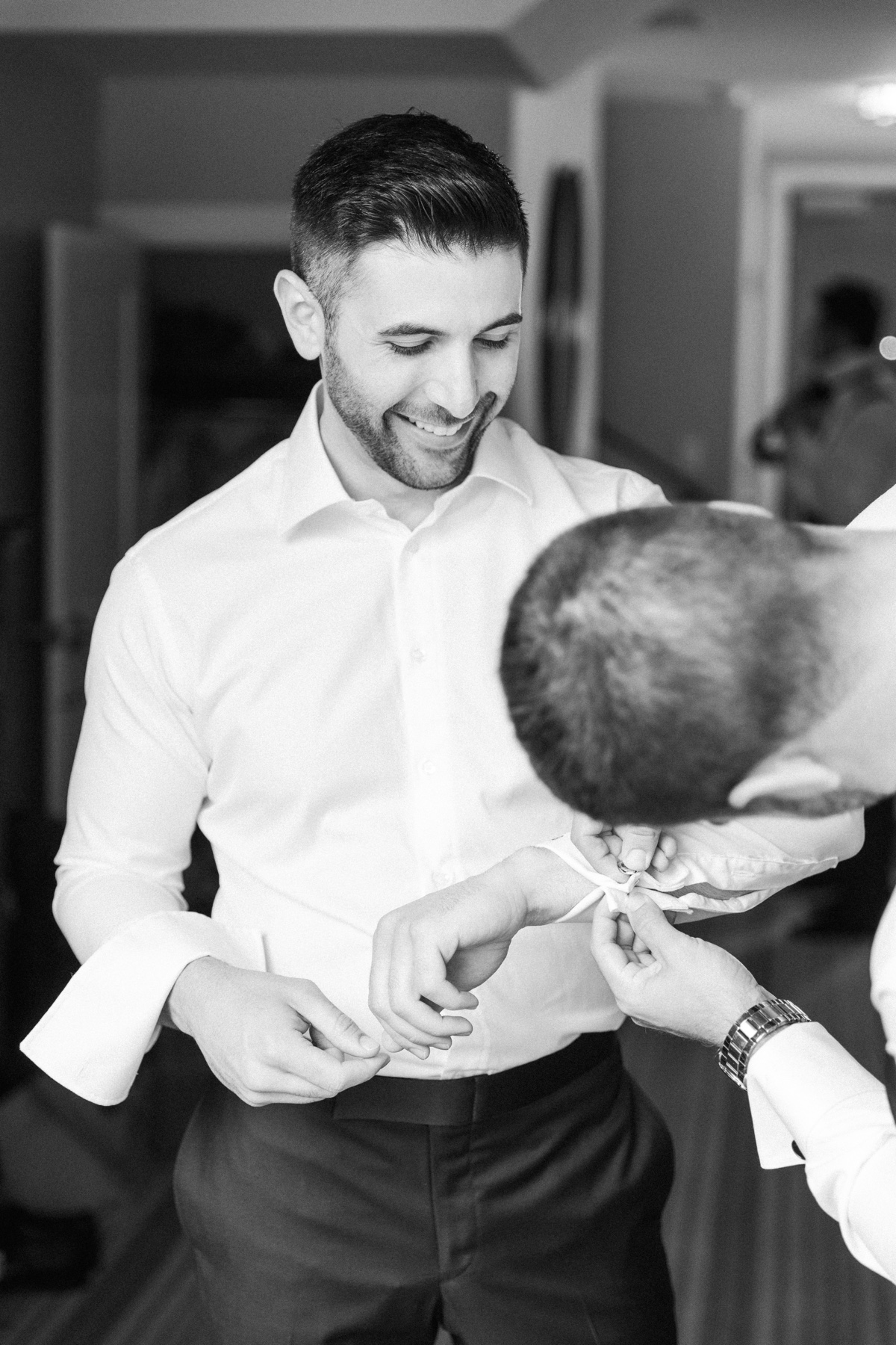 Groom getting ready at Laguna Ranch with natural light and candid moments before the ceremony