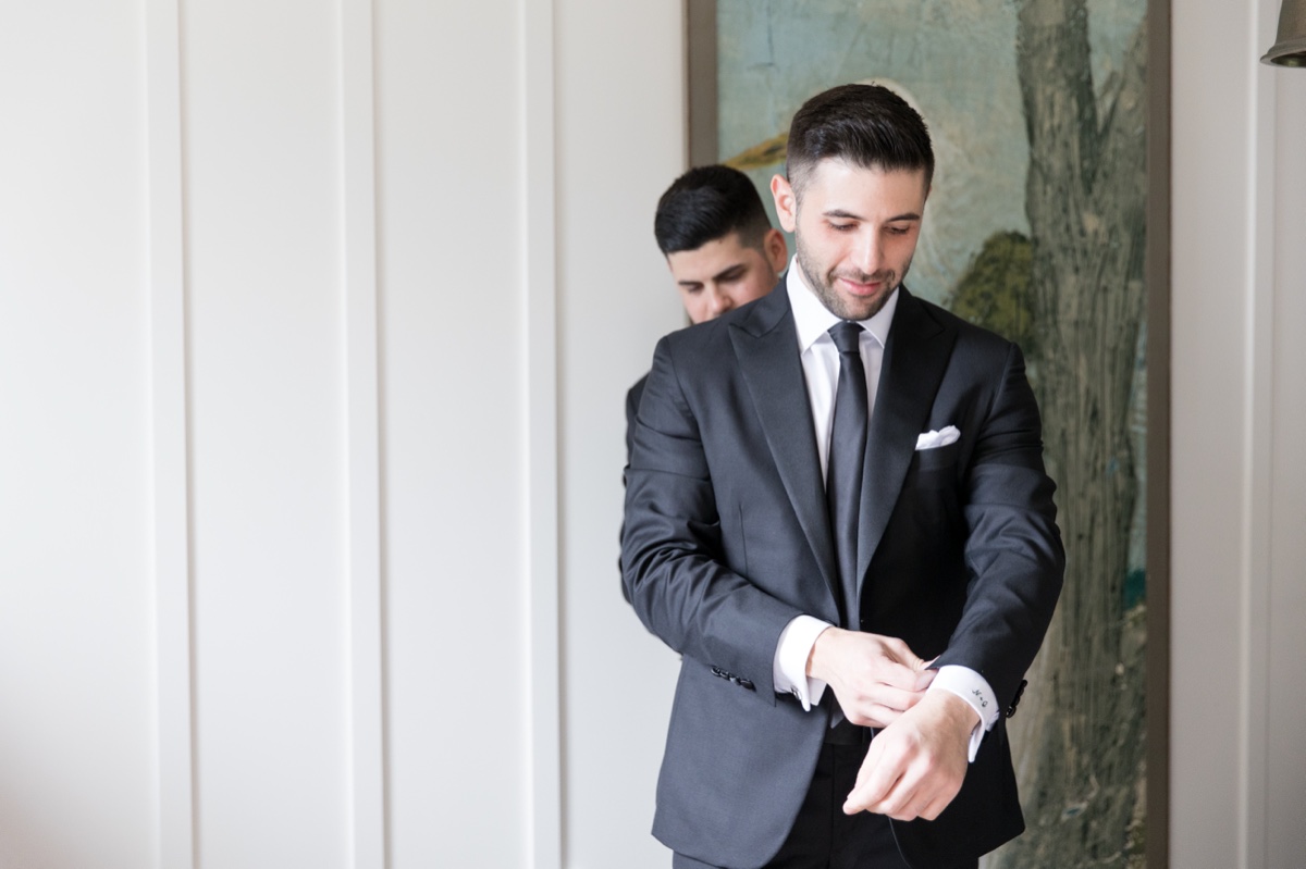 Groom getting ready at Laguna Ranch with natural light and candid moments before the ceremony