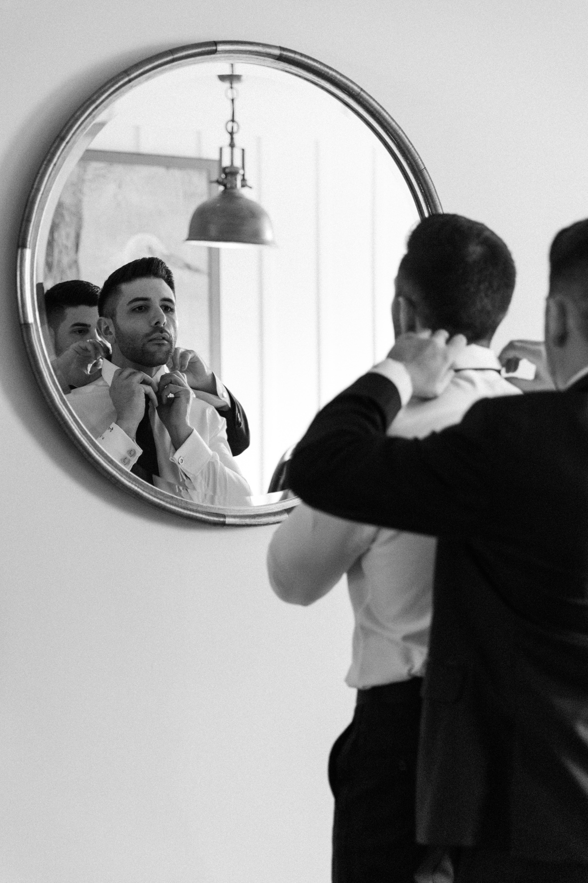 Groom getting ready at Laguna Ranch with natural light and candid moments before the ceremony