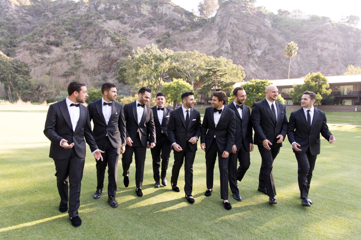 Bridal party at Laguna Ranch with white florals, natural greenery, and candid group moments