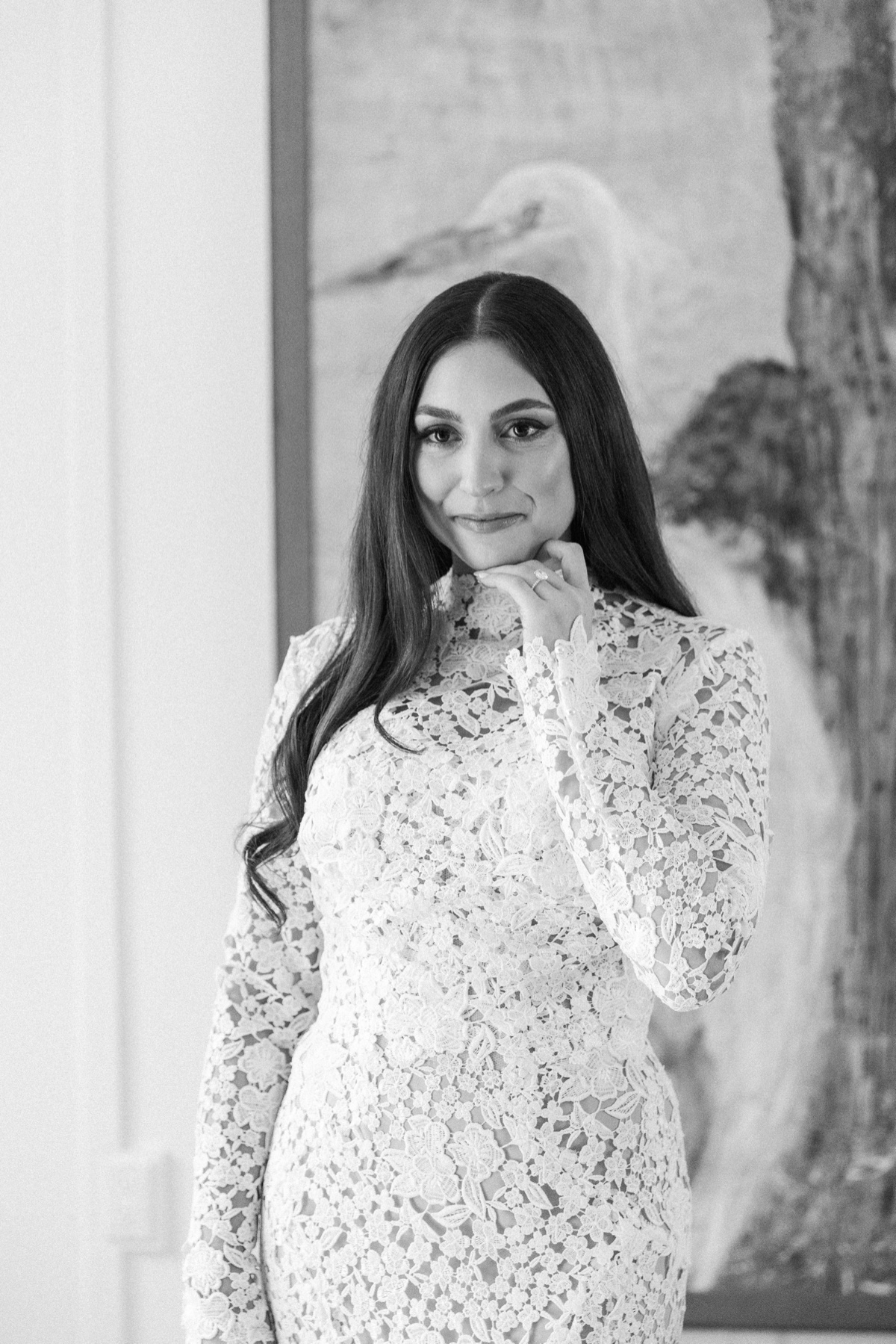 Bride in a long-sleeve lace wedding dress getting ready at Laguna Ranch in Laguna Beach