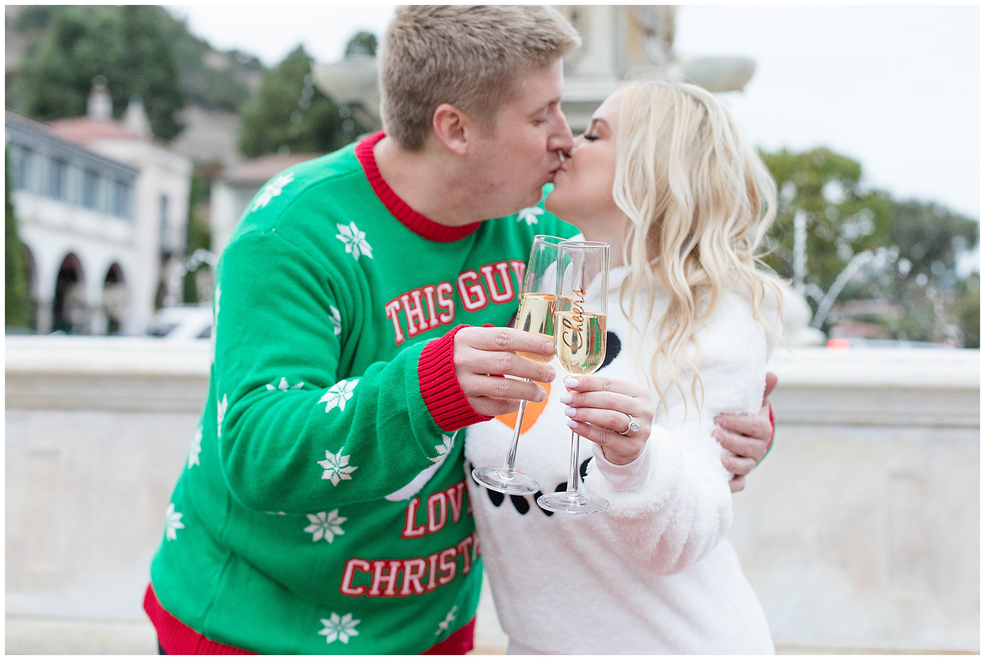 couple in christmas sweaters champagne toast