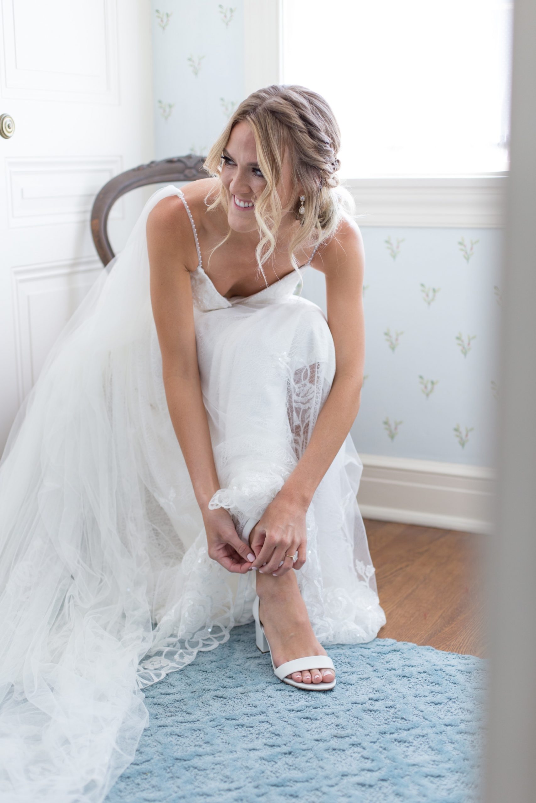 bride putting her shoes on 