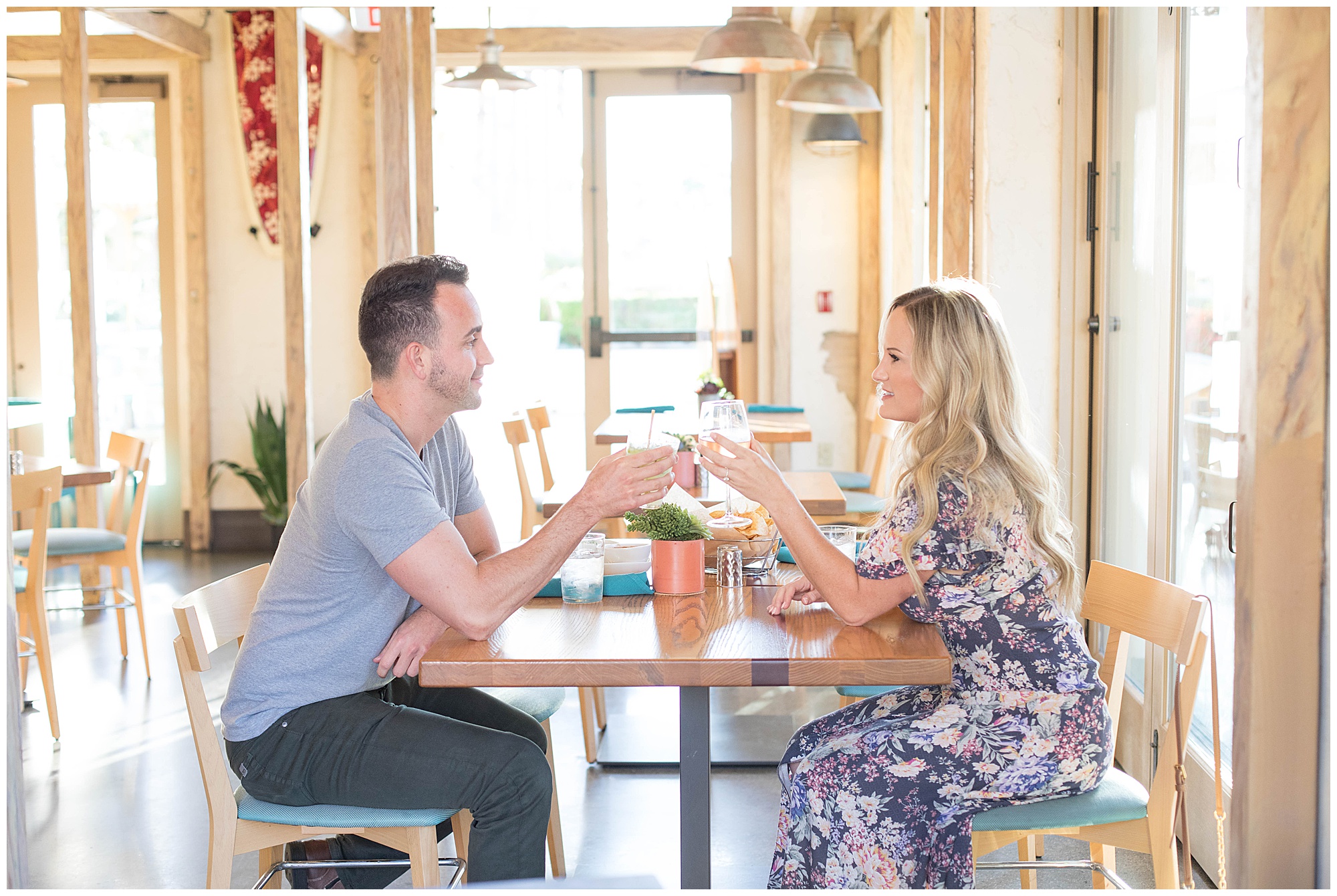 engaged couple drinking at bar in Huntington Beach