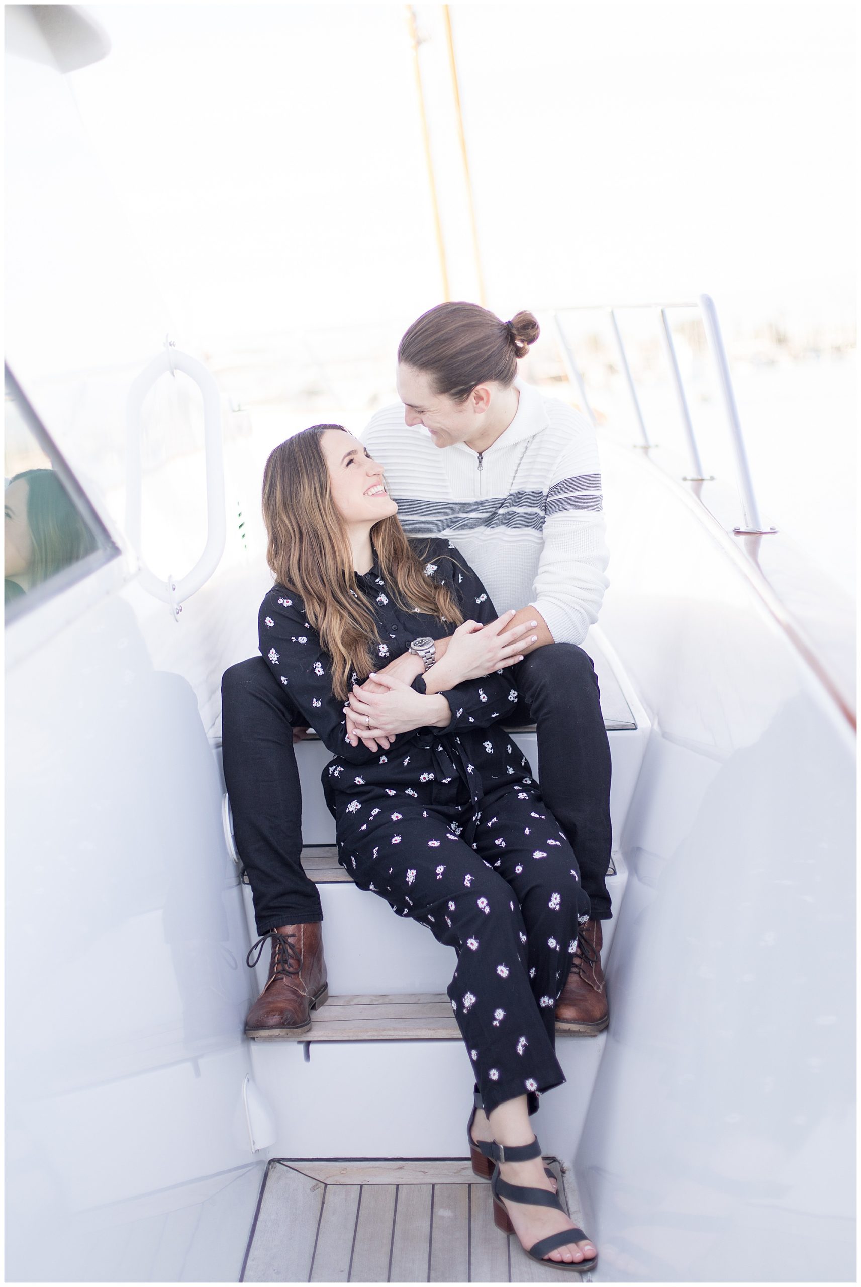engaged couple sitting on yacht