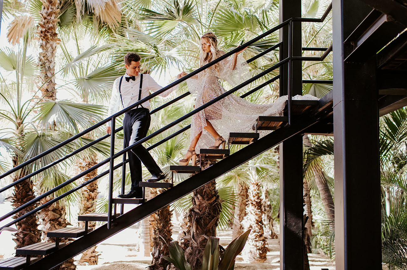 bride and groom walking down the stairs at acre baja