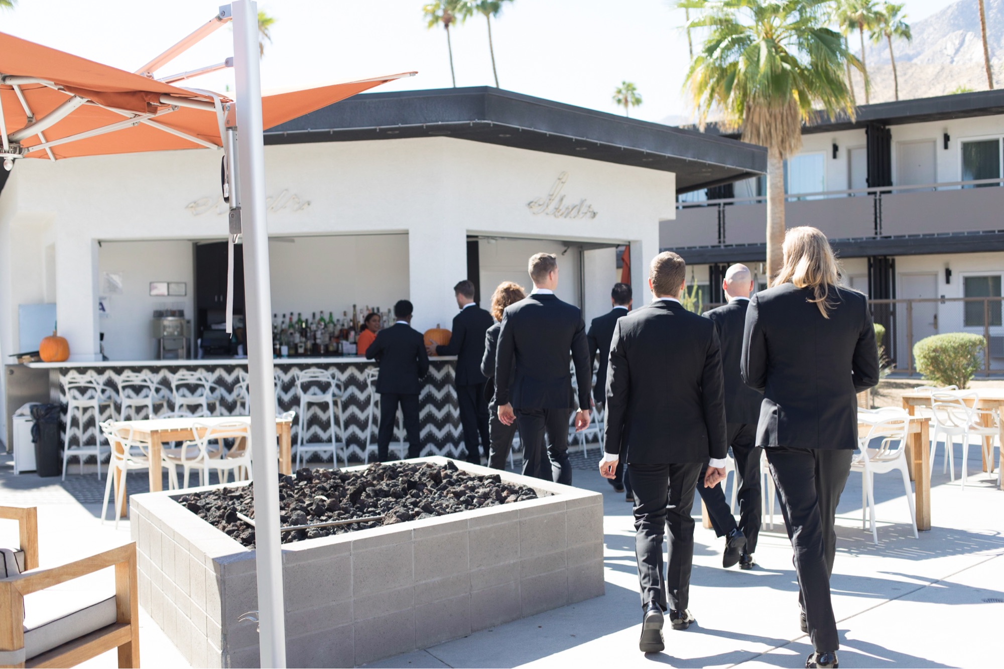 groomsmen walking to a bar