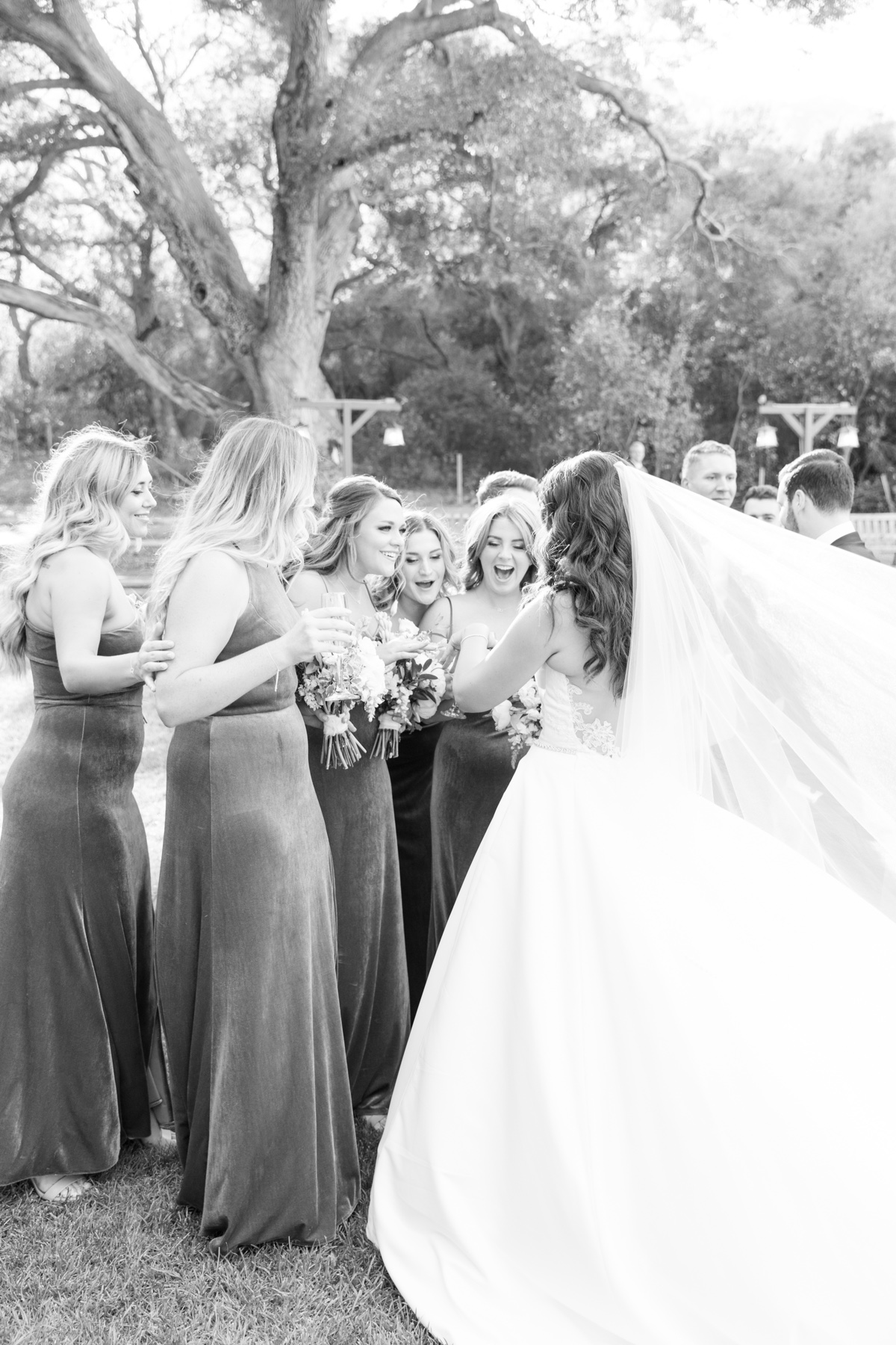 bride showing her bridesmaids her new ring
